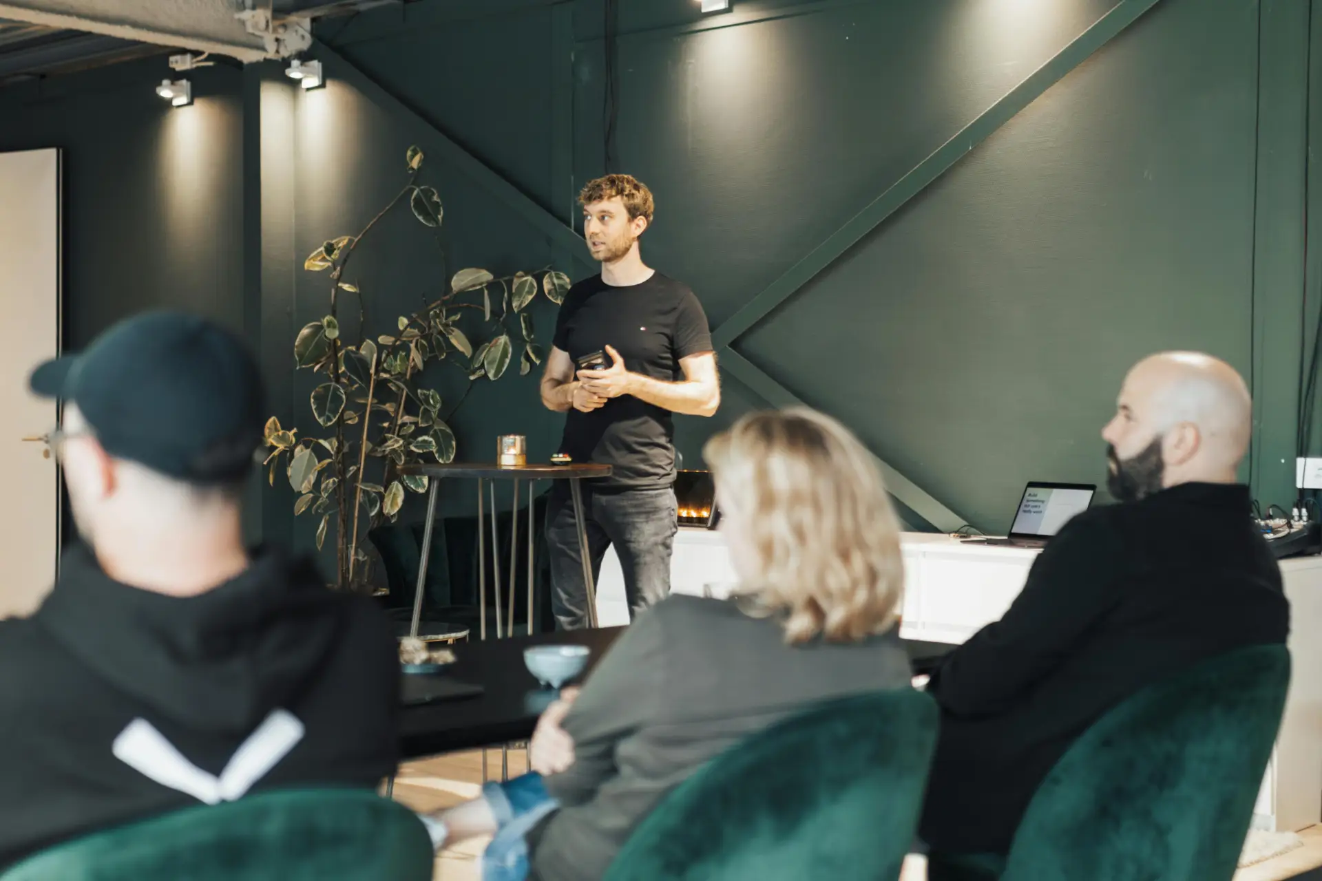 Business presentation in a modern office setting with a diverse group.
