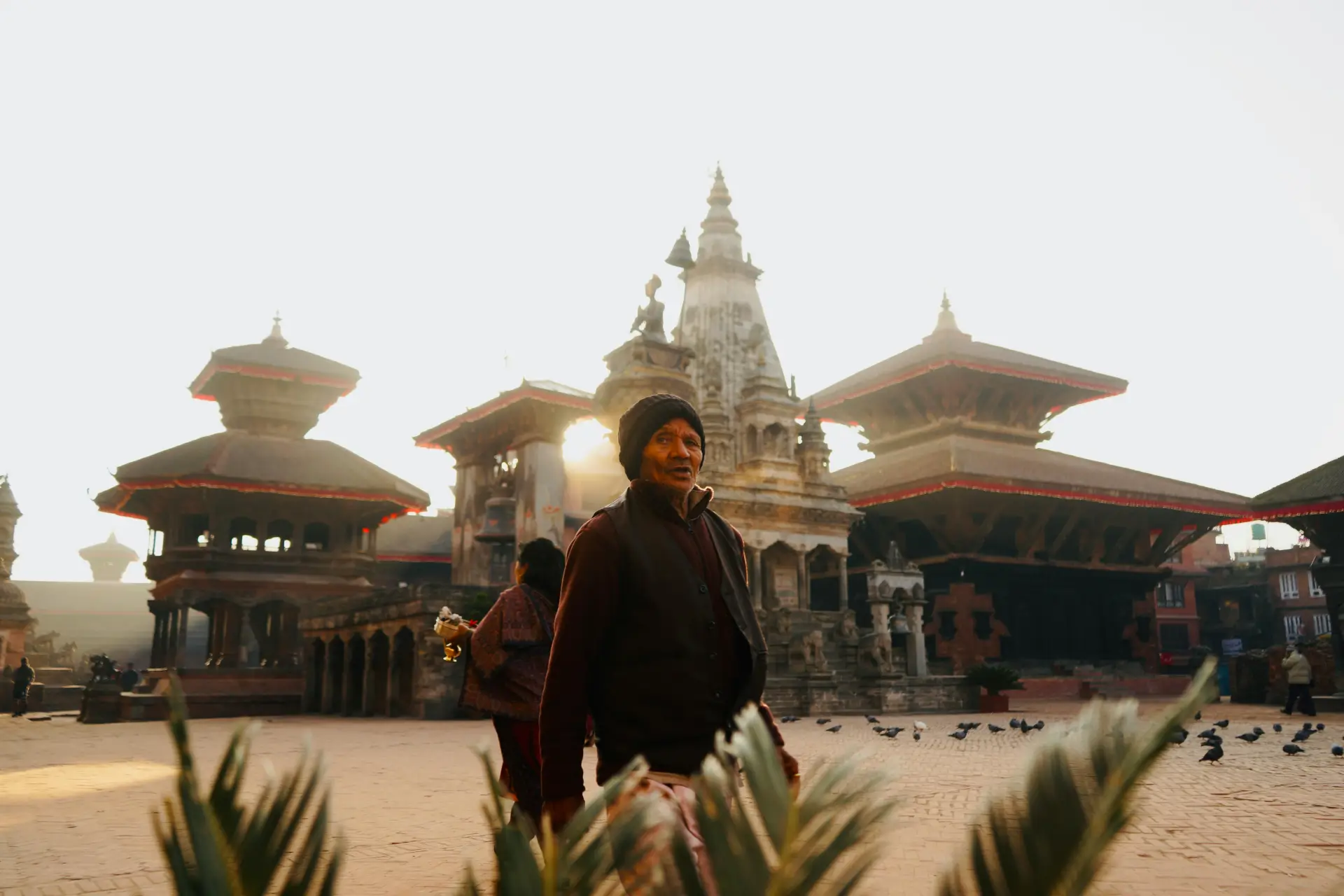 Local people walking through Bhaktapur Durbar Square, Nepal during the day.
