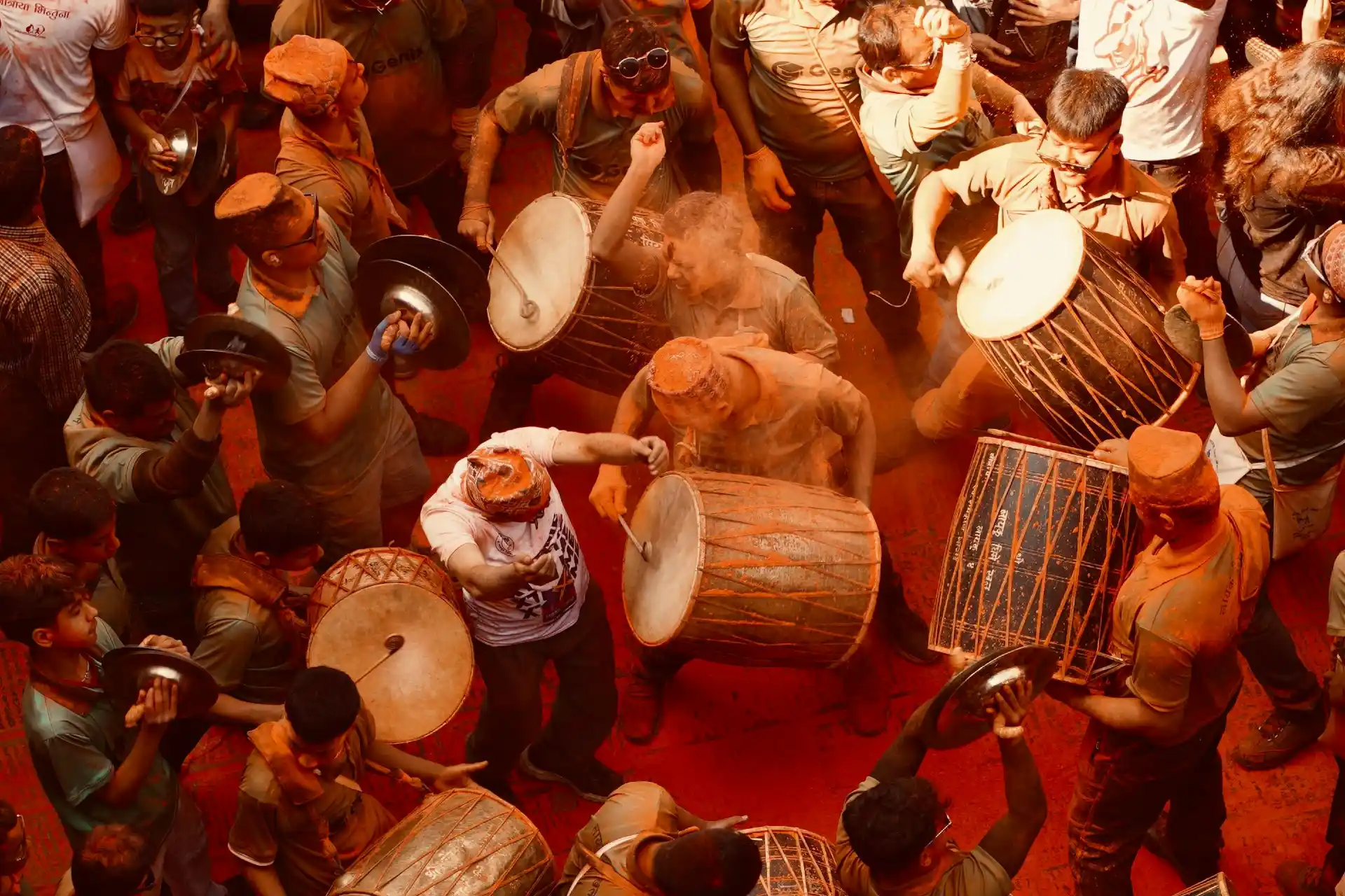 Musicians and crowds celebrate Sindoor Jatra in Madhyapur Thimi, Nepal, with joyful drumming and vibrant colors.
